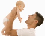 Man Holding Up an Infant