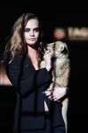 Model Cara Delevingne walks the runway with a lion as she joins TAG Heuer as Brand Ambassador to launch the new 2015 campaign at Palais des Beaux-Arts on January 23, 2015 in Paris, France.