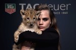 Model Cara Delevingne walks the runway with a lion as she joins TAG Heuer as Brand Ambassador to launch the new 2015 campaign at Palais des Beaux-Arts on January 23, 2015 in Paris, France.