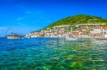 Pogled na prirodnu obalu otoka Visa s borovom šumom i kristalno čistim plavim morem.
